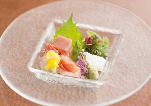 a plastic container filled with food on a plate at Aura Tachibana in Hakone
