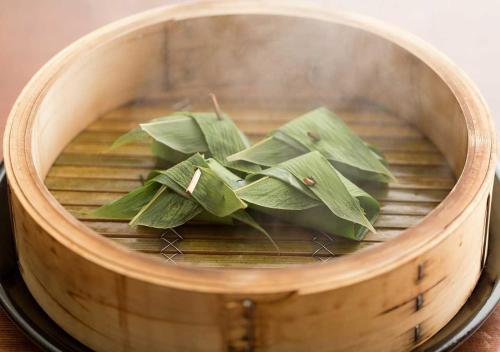 a bunch of green leaves in a wooden barrel at Aura Tachibana in Hakone