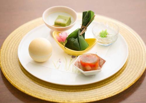 a plate with an egg and other food items on it at Aura Tachibana in Hakone