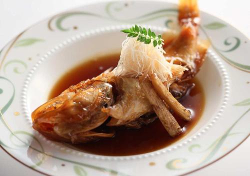 a plate of food with meat and gravy on a table at Aura Tachibana in Hakone