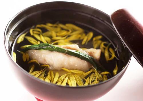 a black bowl of food with meat and pasta at Aura Tachibana in Hakone