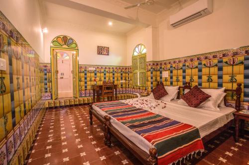 a bedroom with a large bed in a room at THE CHETTINAD HERITAGE in Kānādukāttān