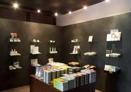 a store display with books on a black wall at Aura Tachibana in Hakone
