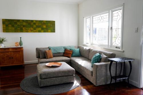 a living room with a couch and a chair at Gallery House Dwellingup in Dwellingup