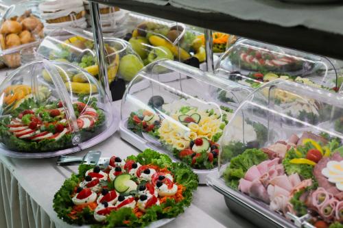 a buffet filled with many different types of food at Primus Hotel & Apartments in Vienna