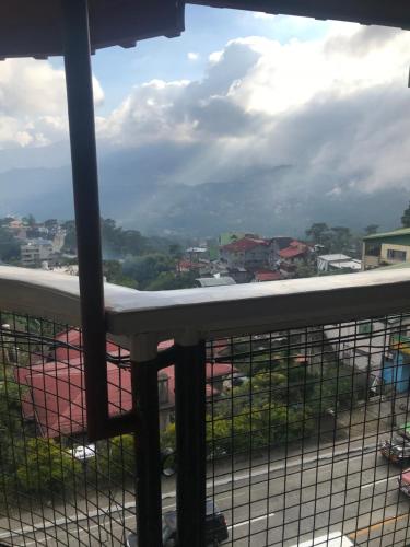 a balcony with a view of a city at ASHBURN'S TRANSIENT BAGUIO - 3rd to 5th floor BASIC SLEEP and GO Accommodation, WITH PARKING, NO ELEVATOR in Baguio