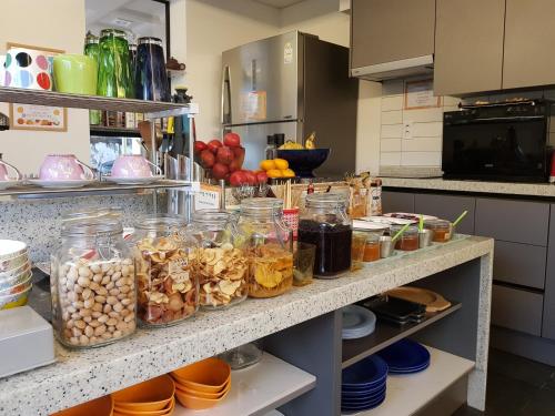 a kitchen with many jars of food on a counter at Namyangju Bukhangang dolcecasa hotel in Namyangju