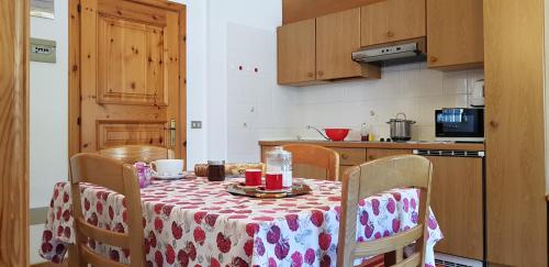 a kitchen with a table with a table cloth on it at Baita al Pian in Bormio