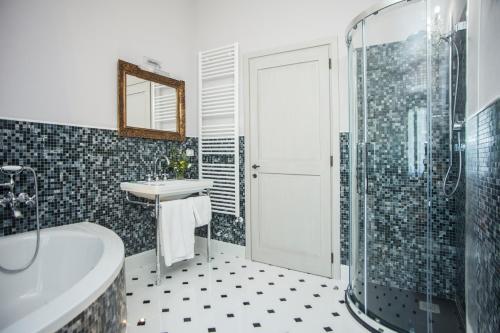 a bathroom with a tub and a sink and a shower at Podere La Contessa B&B in Prato