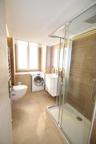 a bathroom with a shower and a washing machine at Jade Duplex - No Better Location In Nice in Nice