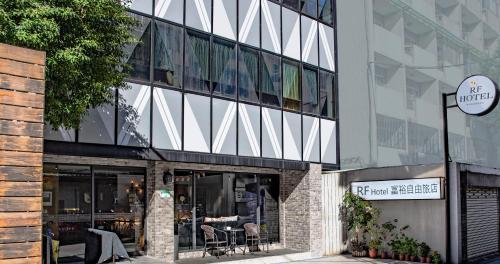 a building with a cafe on the side of it at RF Hotel  Linsen in Taipei