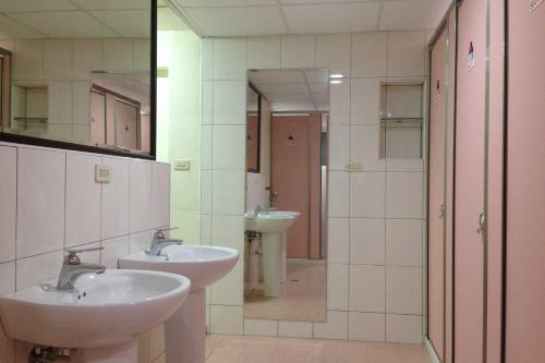 高雄的住宿－巢鴨青年館，浴室配有2个盥洗盆和步入式淋浴间。