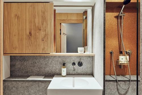 a bathroom with a sink and a mirror at Hotel Wedina an der Alster in Hamburg