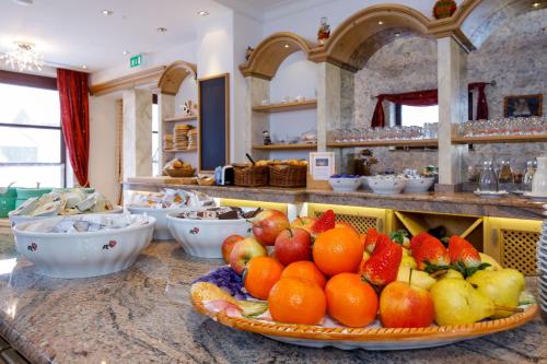 a table with fruit on a counter in a kitchen at Hotel Edelweiss in Hochfilzen