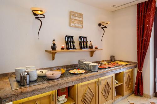 a kitchen with a counter with food on it at Hotel Edelweiss in Hochfilzen