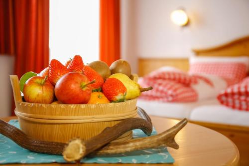 a basket of fruit on a table in a room at Hotel Edelweiss in Hochfilzen