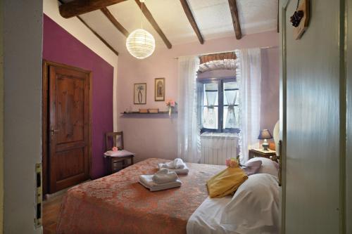 a bedroom with a bed with towels on it at La Chiusuraccia in Barberino di Mugello