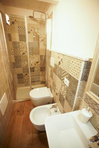 a bathroom with a toilet and a sink and a shower at Dimora Maestà in Putignano