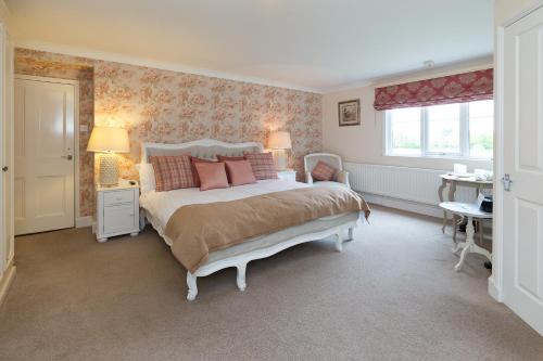 a bedroom with a bed and a desk and a window at Whitethorn Bed and Breakfast in Congleton