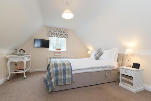 a small bedroom with a bed and a window at Whitethorn Bed and Breakfast in Congleton