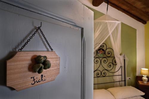 a door with a sign hanging on a wall at La Chiusuraccia in Barberino di Mugello