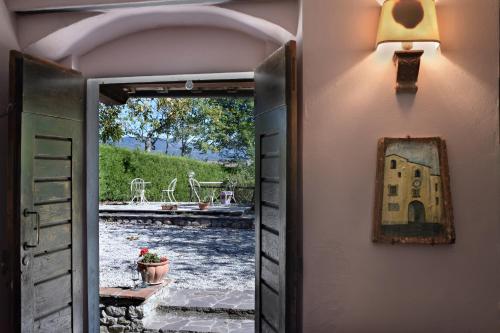 an open door to a house with a pool at La Chiusuraccia in Barberino di Mugello