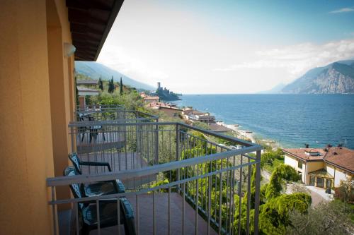 a balcony with a view of the ocean at Hotel Casa Marinella in Malcesine
