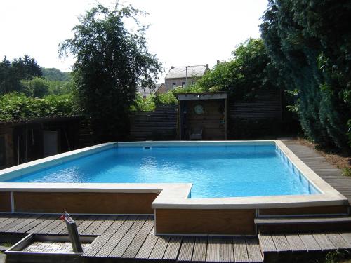 a large swimming pool sitting on a wooden deck at Celine - Maurenne in Hastière-Lavaux