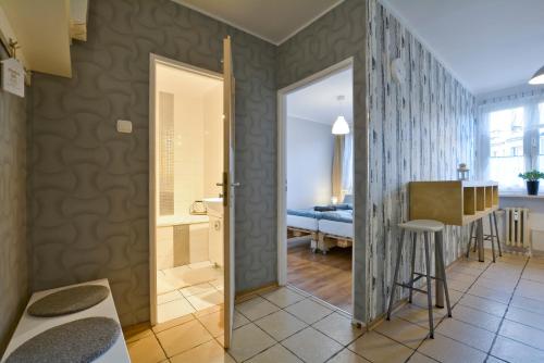 a bathroom with a walk in shower next to a room at Apartament Dzień dobry in Wałbrzych
