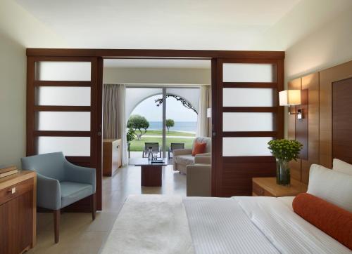 a bedroom with a bed and a living room at Apollo Blue in Faliraki