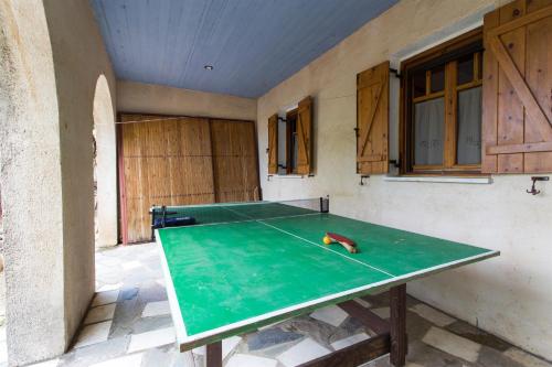 a ping pong table in the corner of a room at Mavilia Traditional Guesthouse in Ligourio