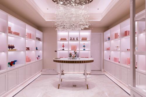a dressing room with a chandelier and a table at The Langham, Hefei in Hefei