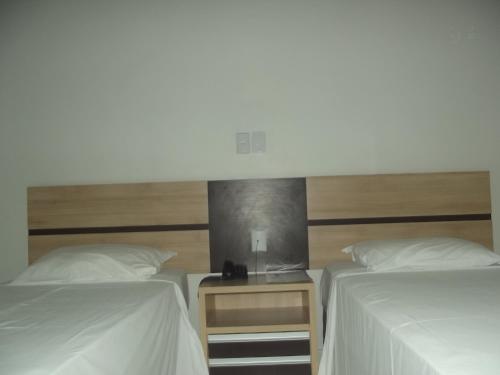 Ένα ή περισσότερα κρεβάτια σε δωμάτιο στο Hotel Estrela Palmas