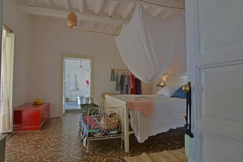 a bedroom with a bed with a canopy at casa 3 archi in Alicudi