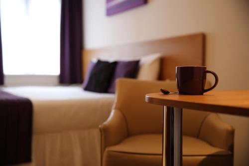 a coffee cup sitting on a table in a hotel room at CIM Business Centre in Maidenhead