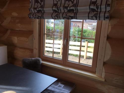 a window in a log cabin with a table at Chalet Karin in Hochfilzen