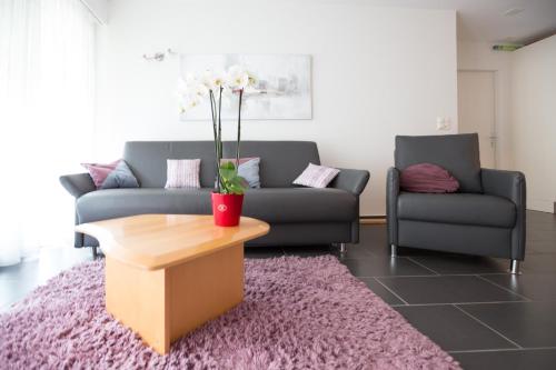 a living room with two couches and a coffee table at Haus Fortuna in Leukerbad