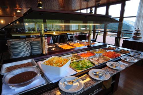 a buffet line with many different types of food at INATEL Piodao in Piódão