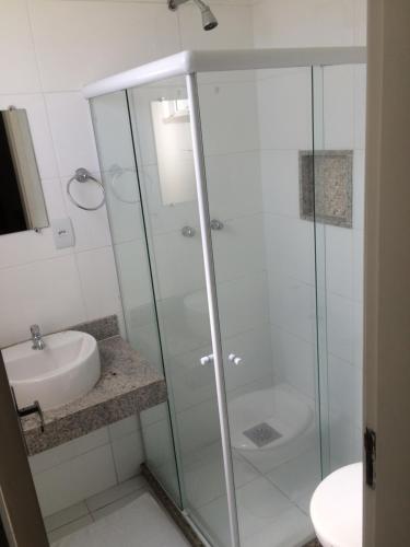 a bathroom with a glass shower and a sink at Hotel Campos Plaza in Campos dos Goytacazes