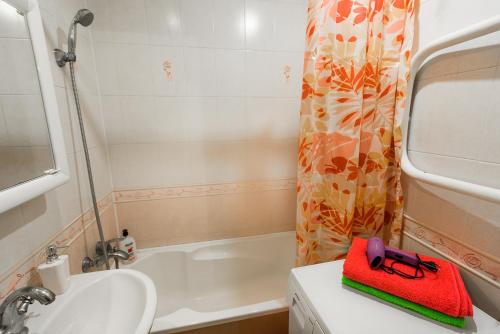 a bathroom with a sink and a red purse on a counter at Большая квартира на пр. МИРА in Salihorsk