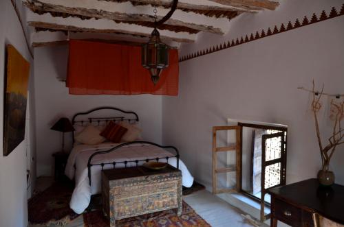 um quarto com uma cama e um espelho em Kasbah Tigmi N'Oufella em Telouet