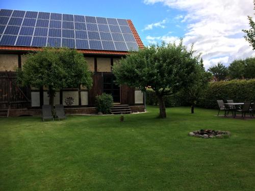 a house with a lot of solar panels on a yard at Storchenblick in Schlepzig