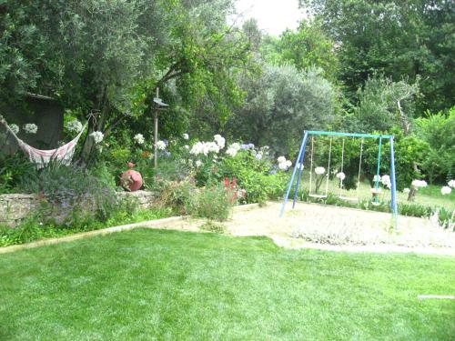 a garden with a swing in the grass at Casa De Carcavelos in Cabeceiras de Basto