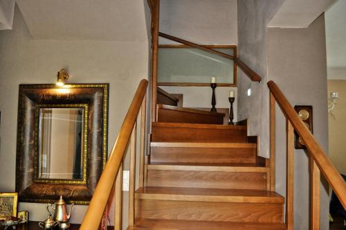 a stairway with a mirror and a mirror at Chalet Coquelicot (Co-cli-co) relax in nature in Kalavrita