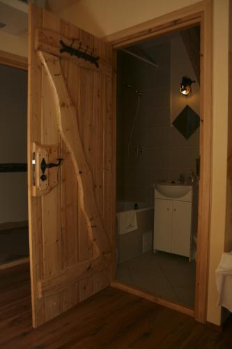 a bathroom with a glass door with a tree cut out at Impresja Krasiczyn in Przemyśl