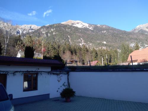 a white building with a view of a mountain at Ruhe am See in Presseggersee