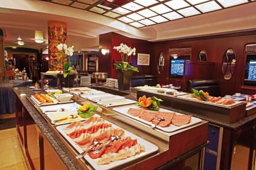 a buffet line with many different types of food at Seaside Park Hotel Leipzig in Leipzig