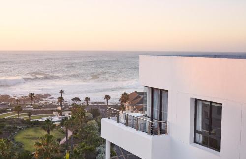 a white building with a view of the ocean at President Hotel in Cape Town