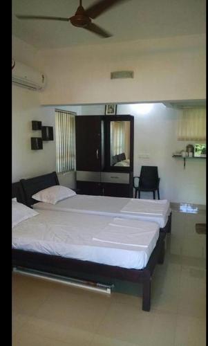 a bedroom with two beds in a room at ABRU'S Holidays International Travelers in Alleppey