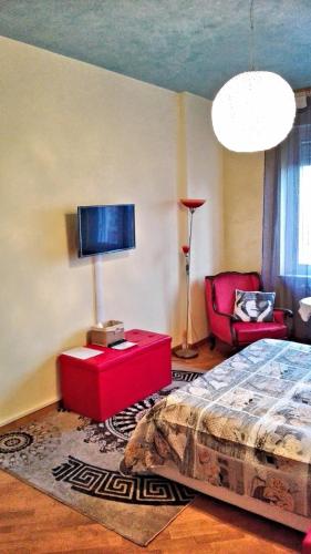 a bedroom with a bed and a red table at Luna del Belvedere in Asti